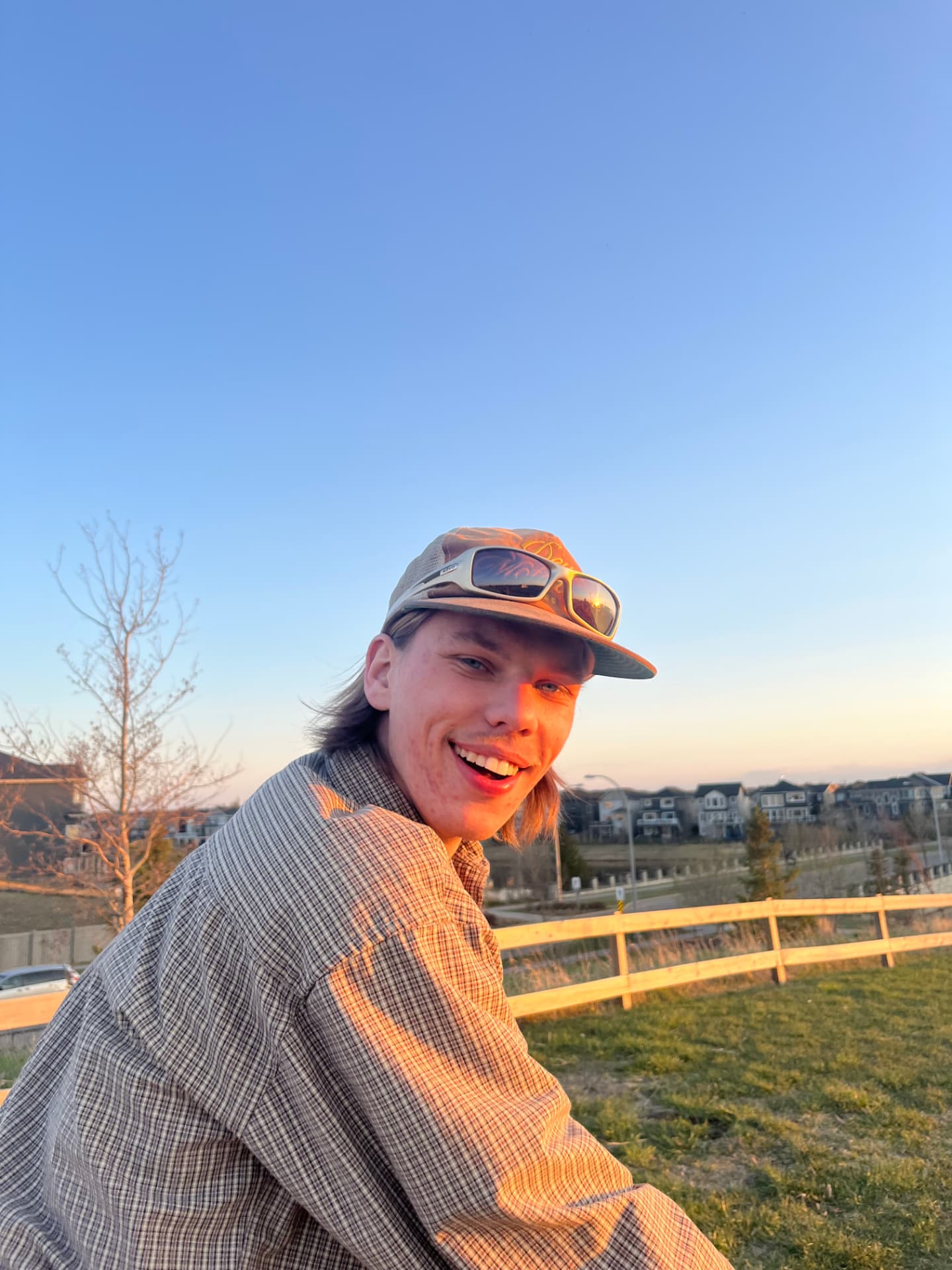 Owen smiling outdoors at sunset in Edmonton