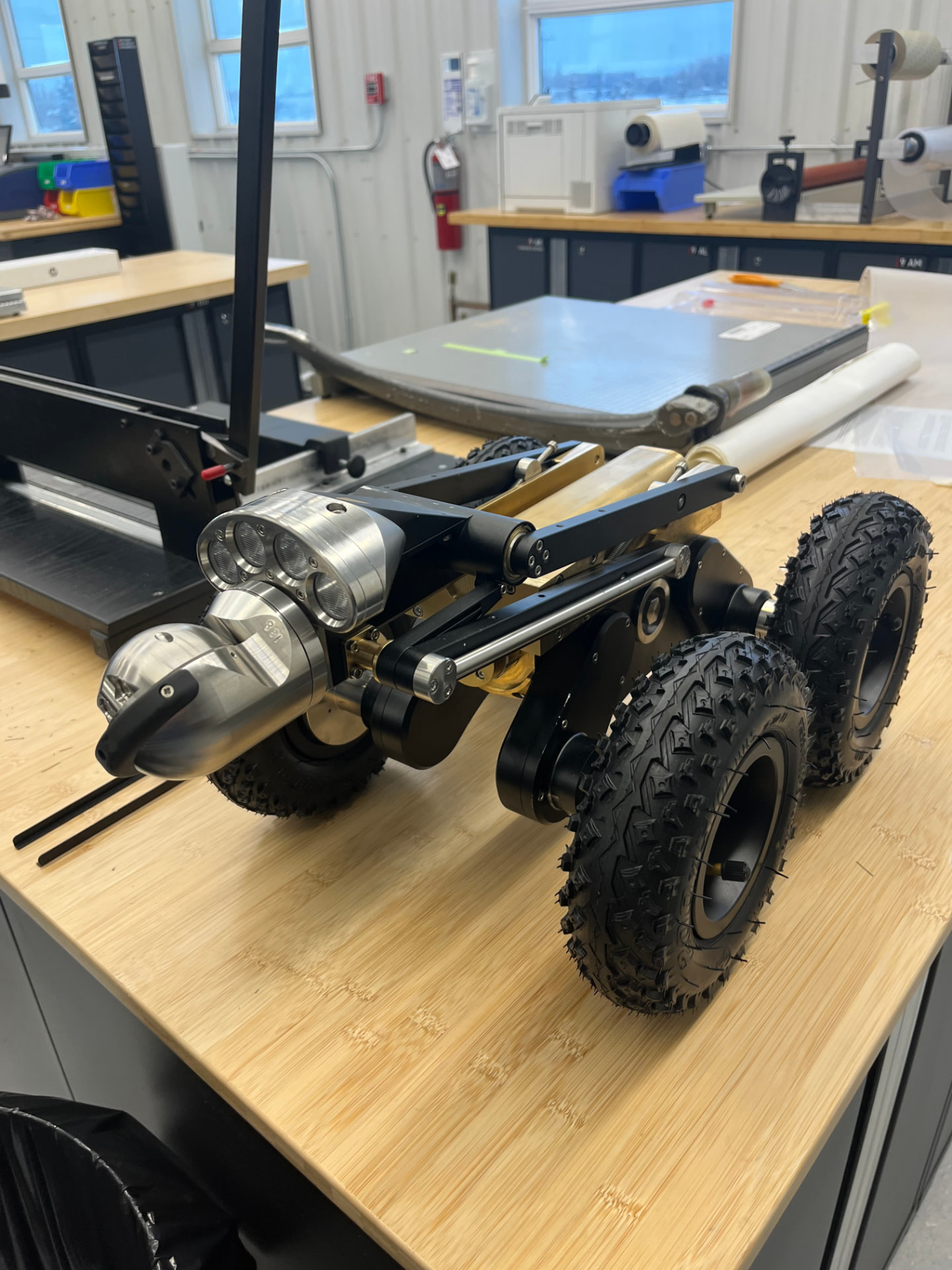 A small wheeled rover prototype on a workbench