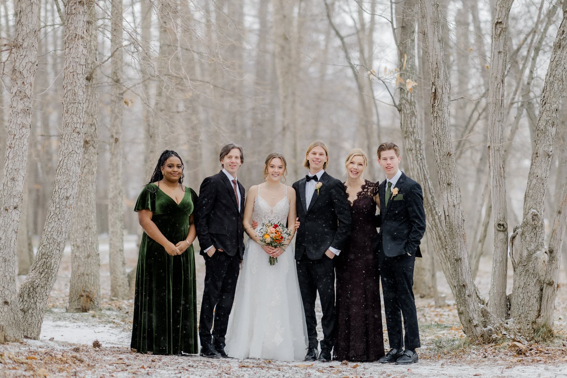 Owen with family at a snowy outdoor wedding
