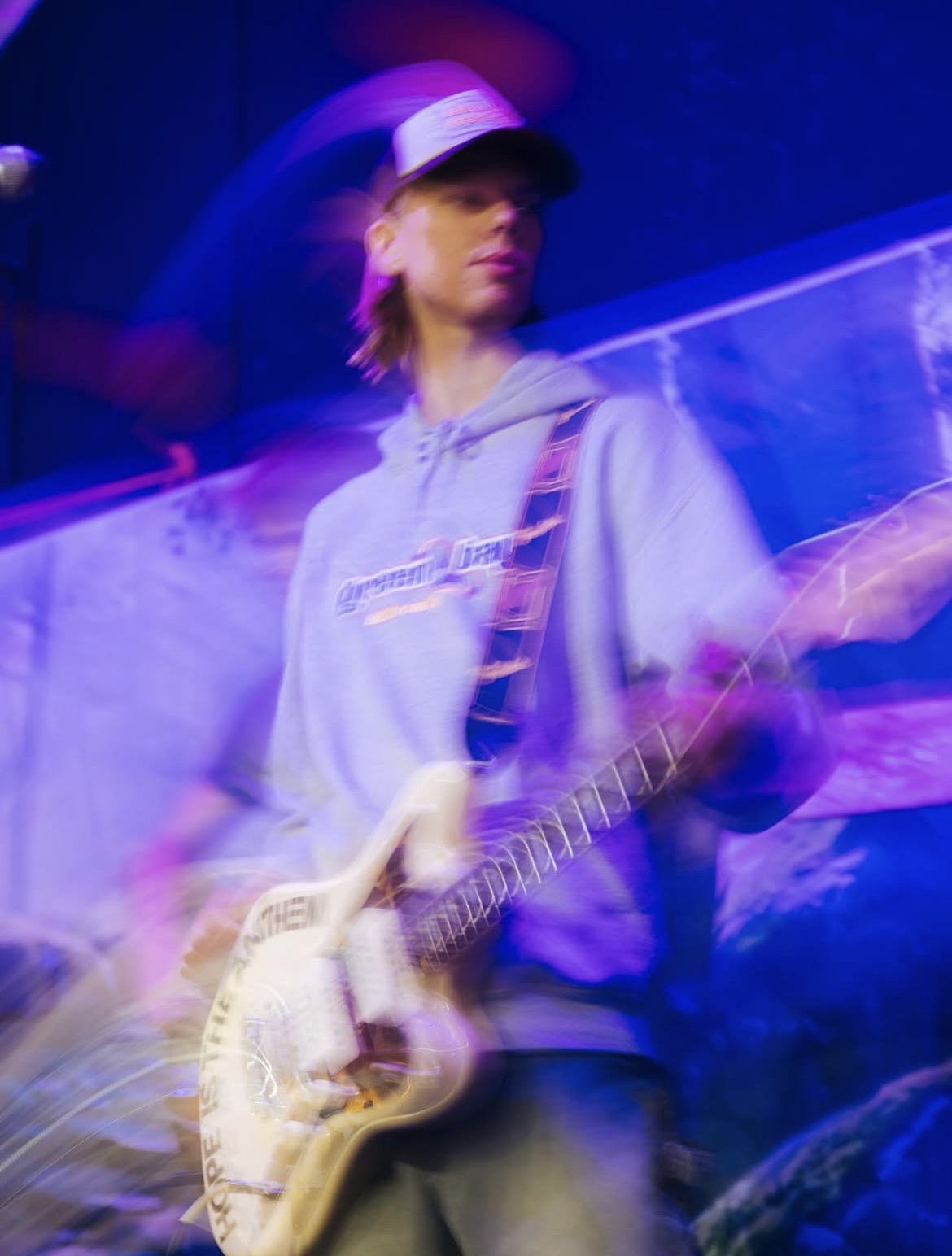 Owen playing electric guitar under purple stage lights