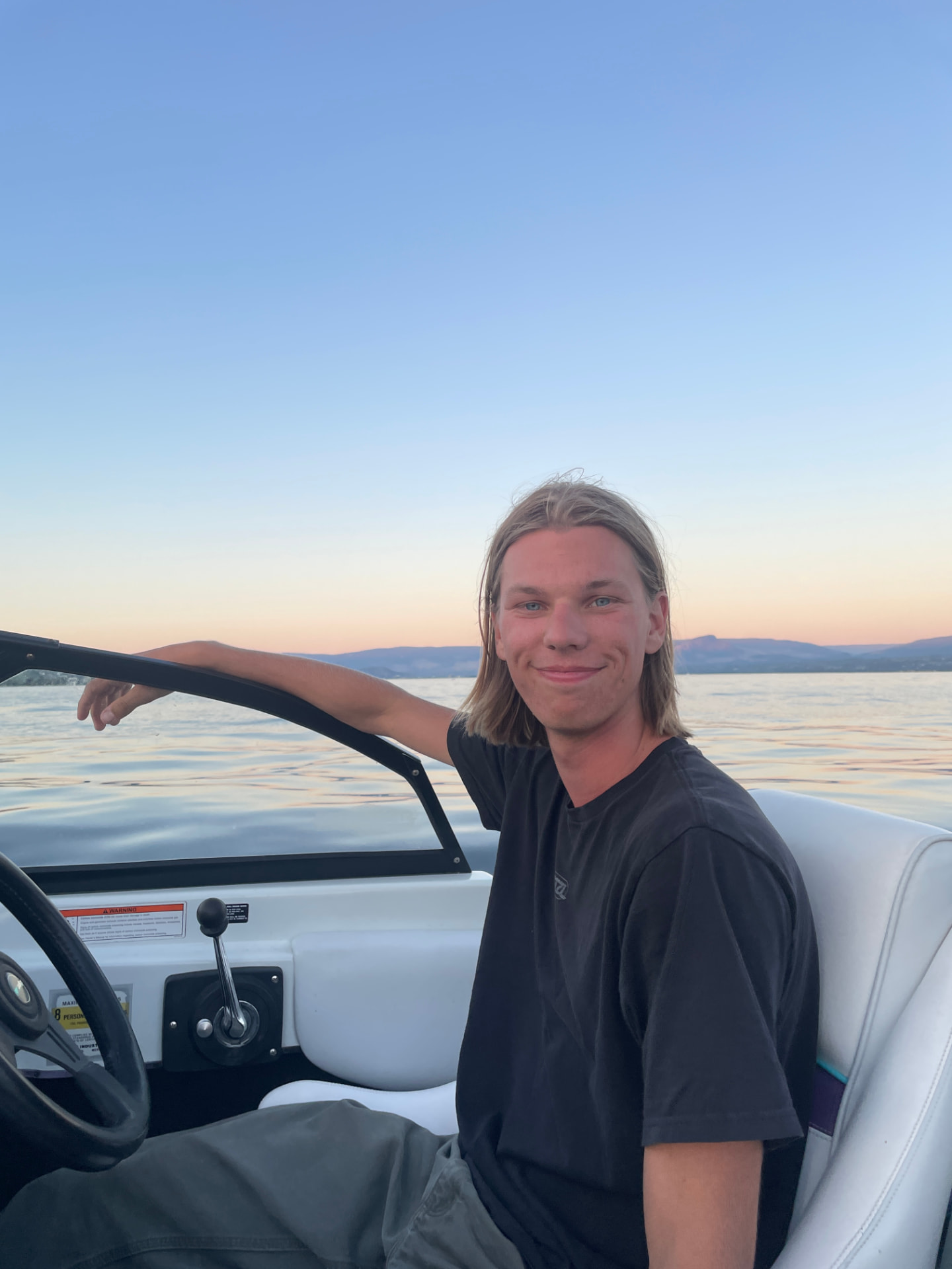 Owen relaxing on a boat at sunset